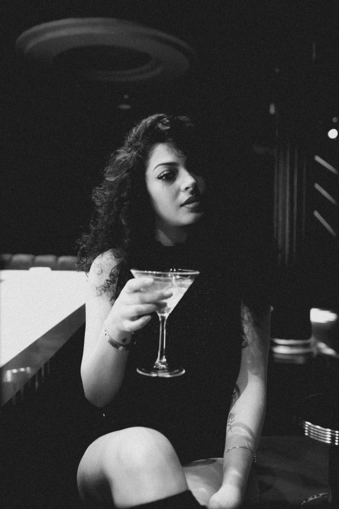 A guest with a martini at the bar
